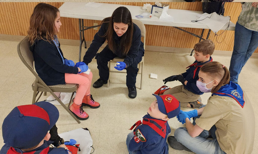 Scouts watch a first-aid demonstration at event with Empress.