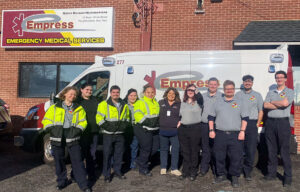 Empress North Academy graduates pose in front of ambulance.
