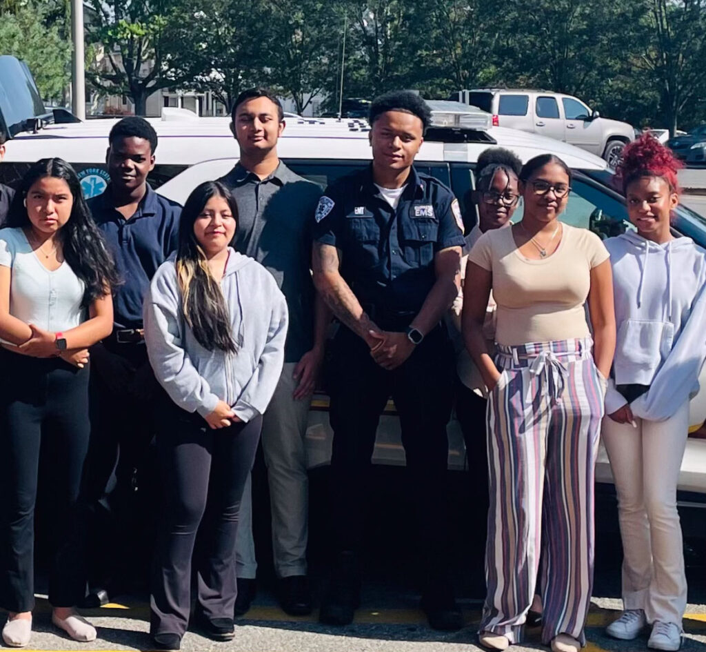 EMT/Outreach Coordinator Omar Stout, center, teaches students at White Plains High School about EMS work.