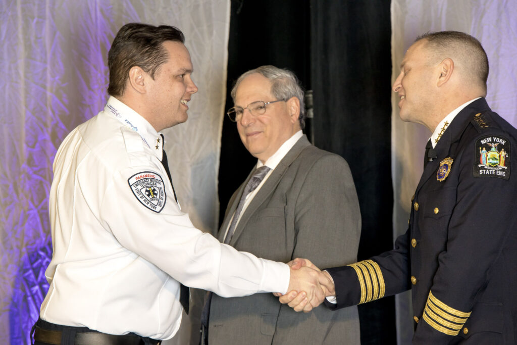 People shaking hands at conference.