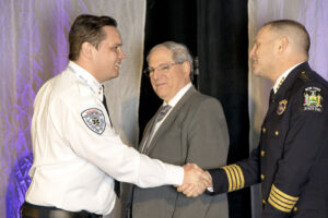 People shaking hands at conference.