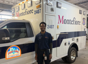 A man stands in front of an ambulance.
